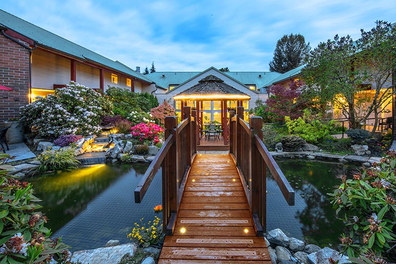 Garden courtyard with bridge and lush plantings